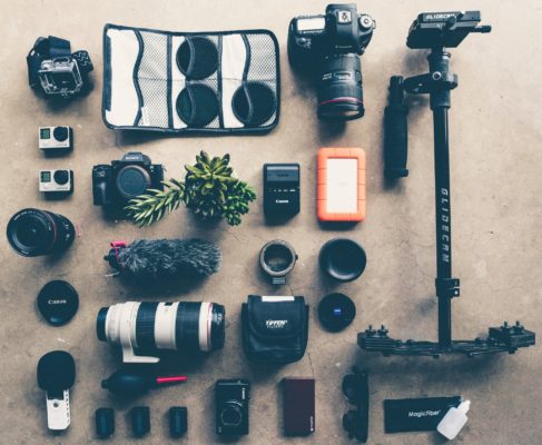 a large flat lay of lots of professional camera equipment