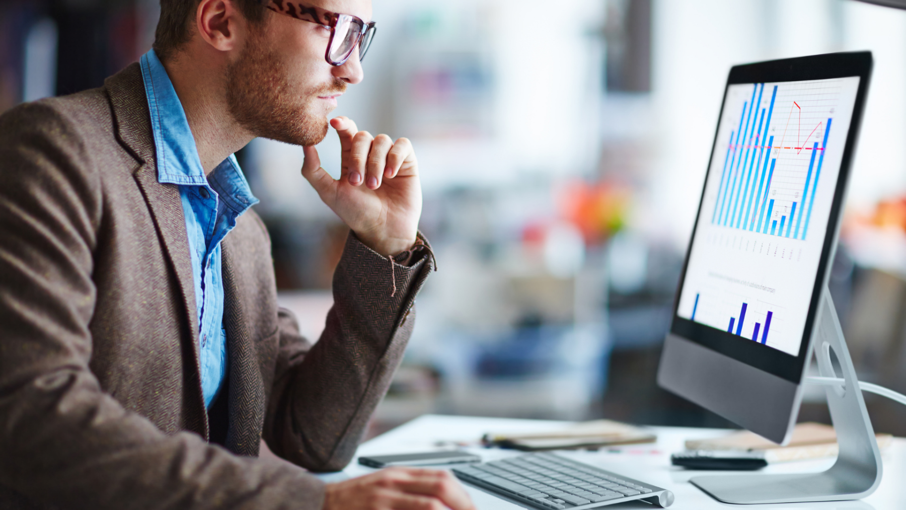 Man staring at keyword research graphs