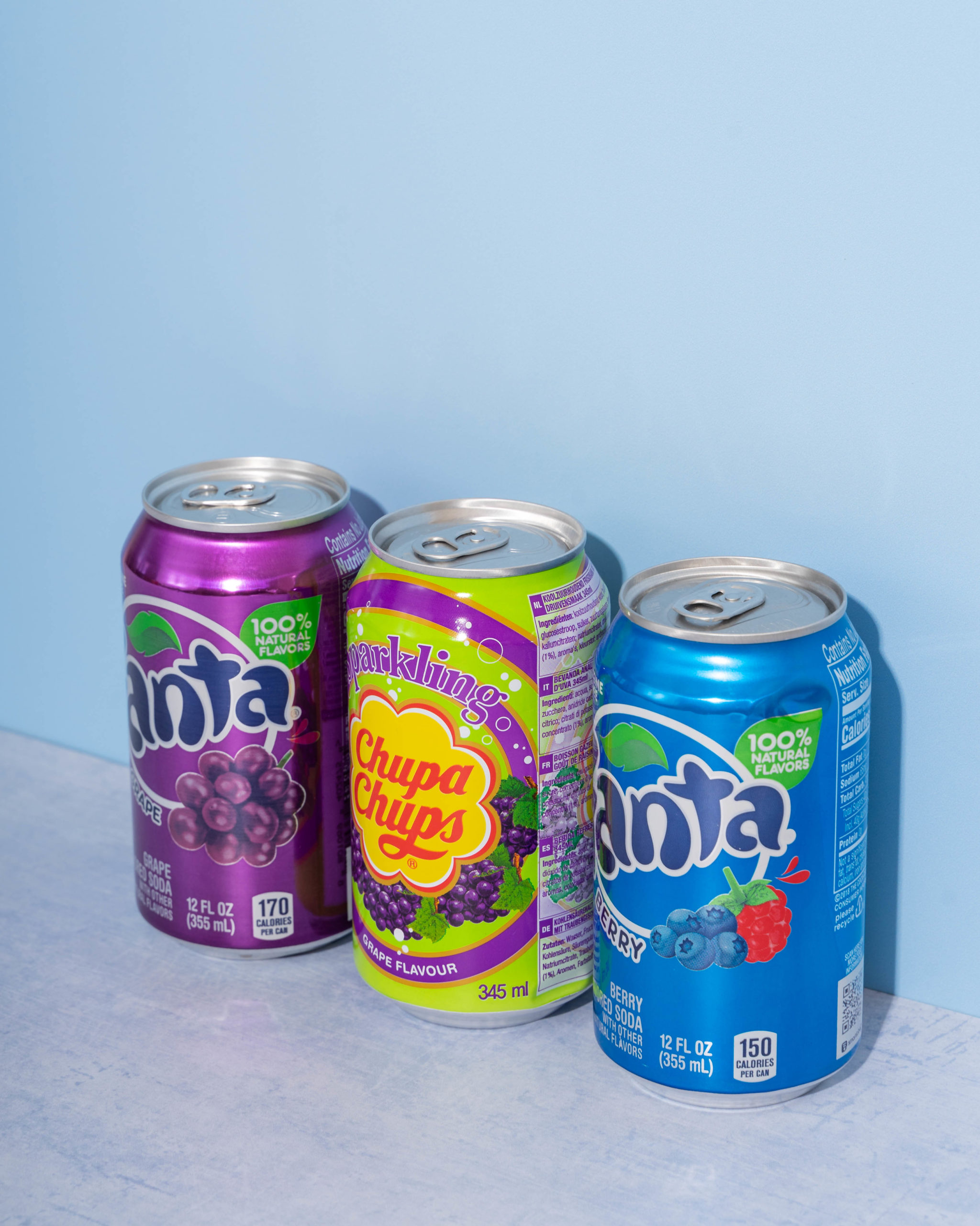 canned fizzy pop on a blue background