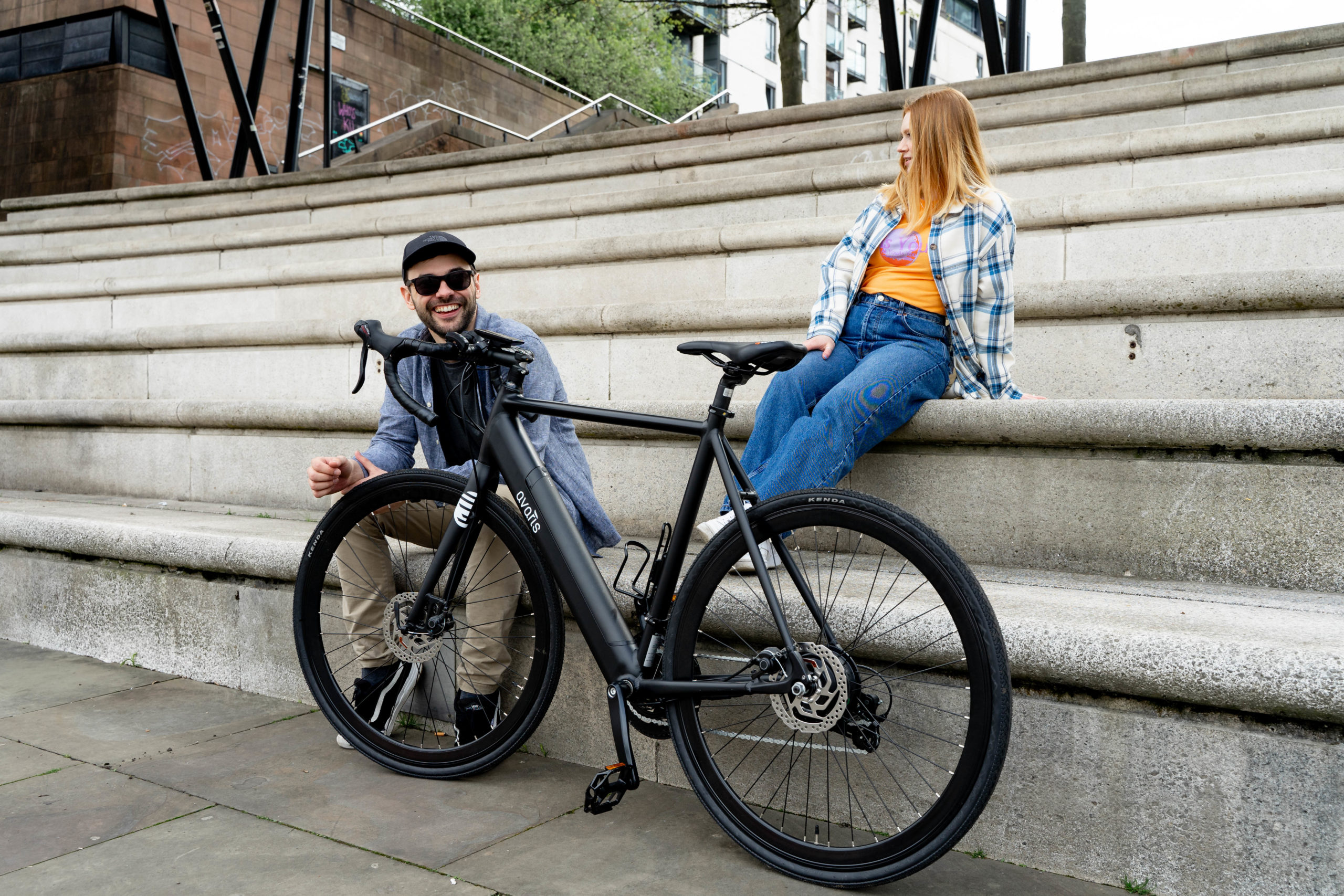 friends hanging out on steps with ebike