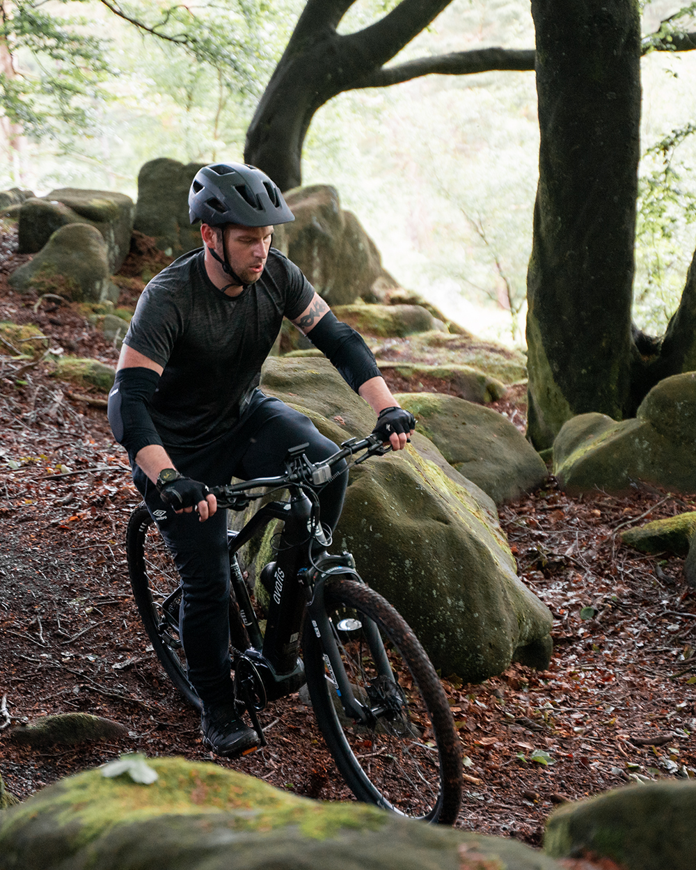 man riding a bicycle in the woods