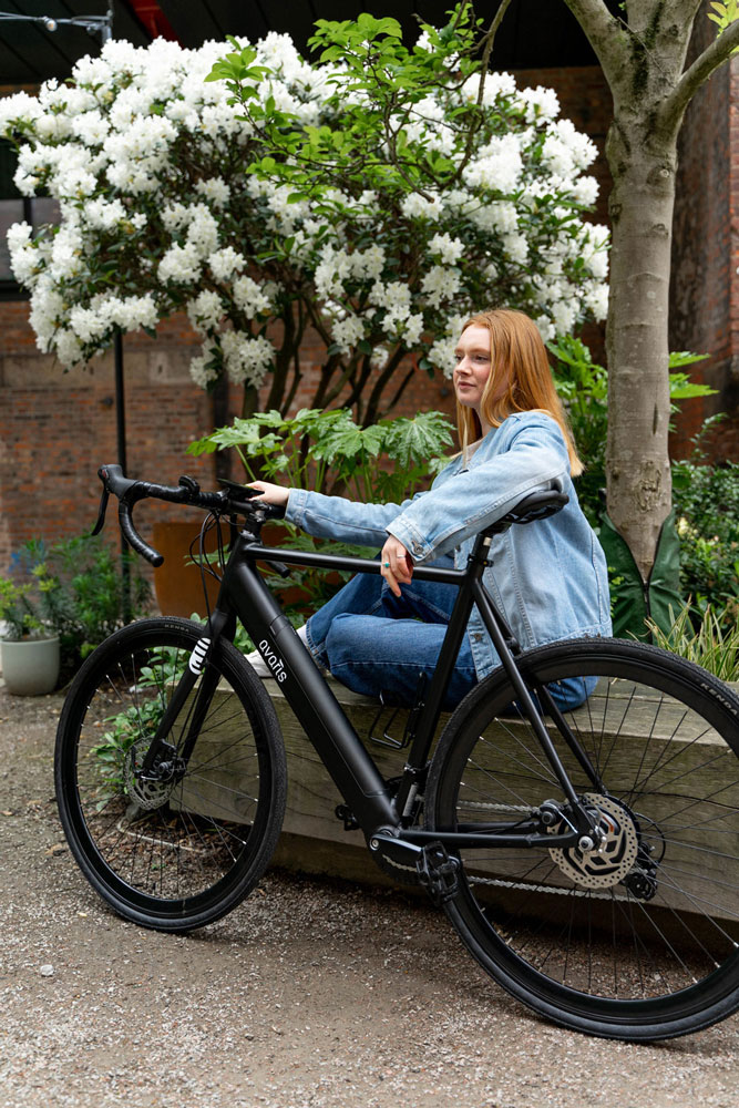 lady with road ebike in a park