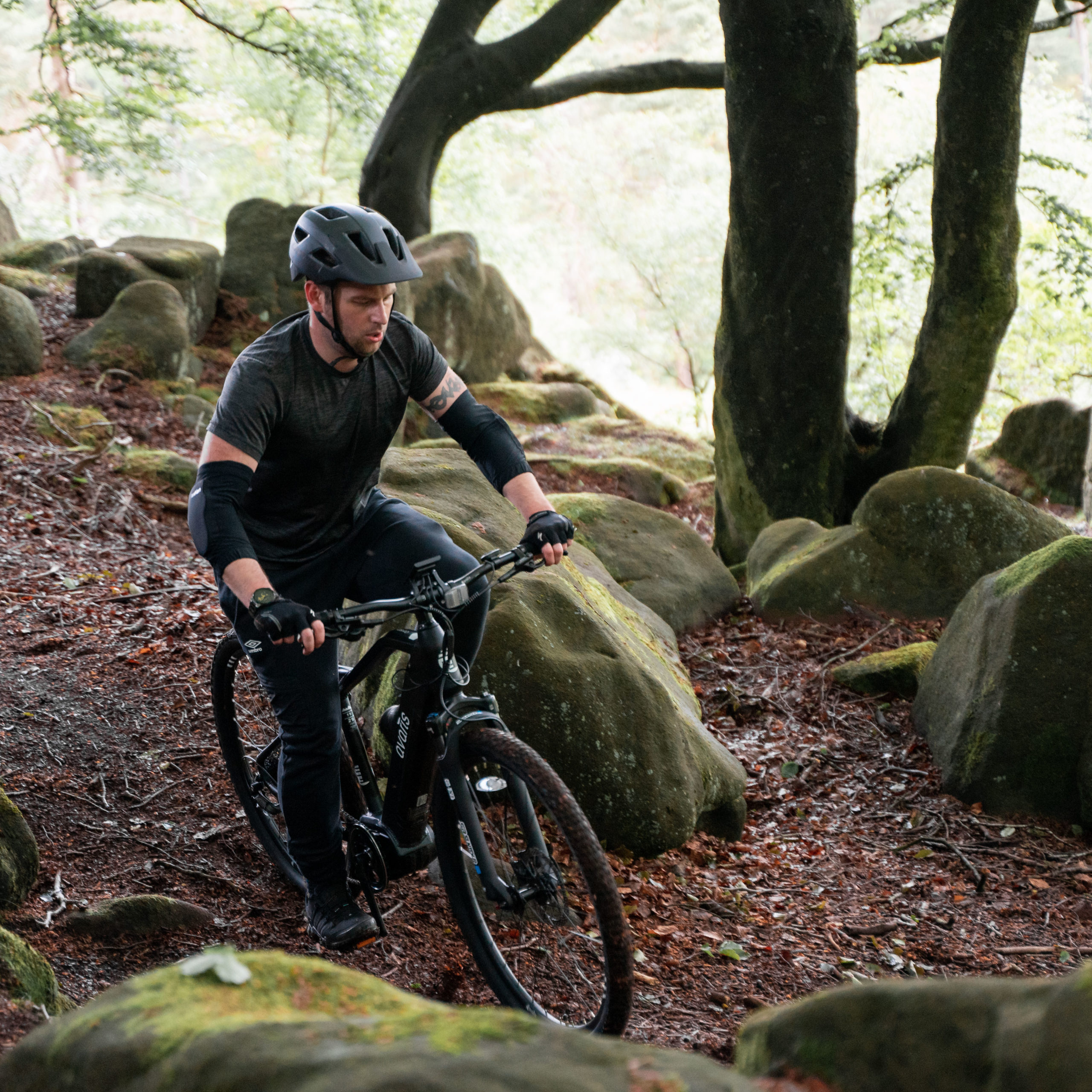 man on mountain bike trail in the woods