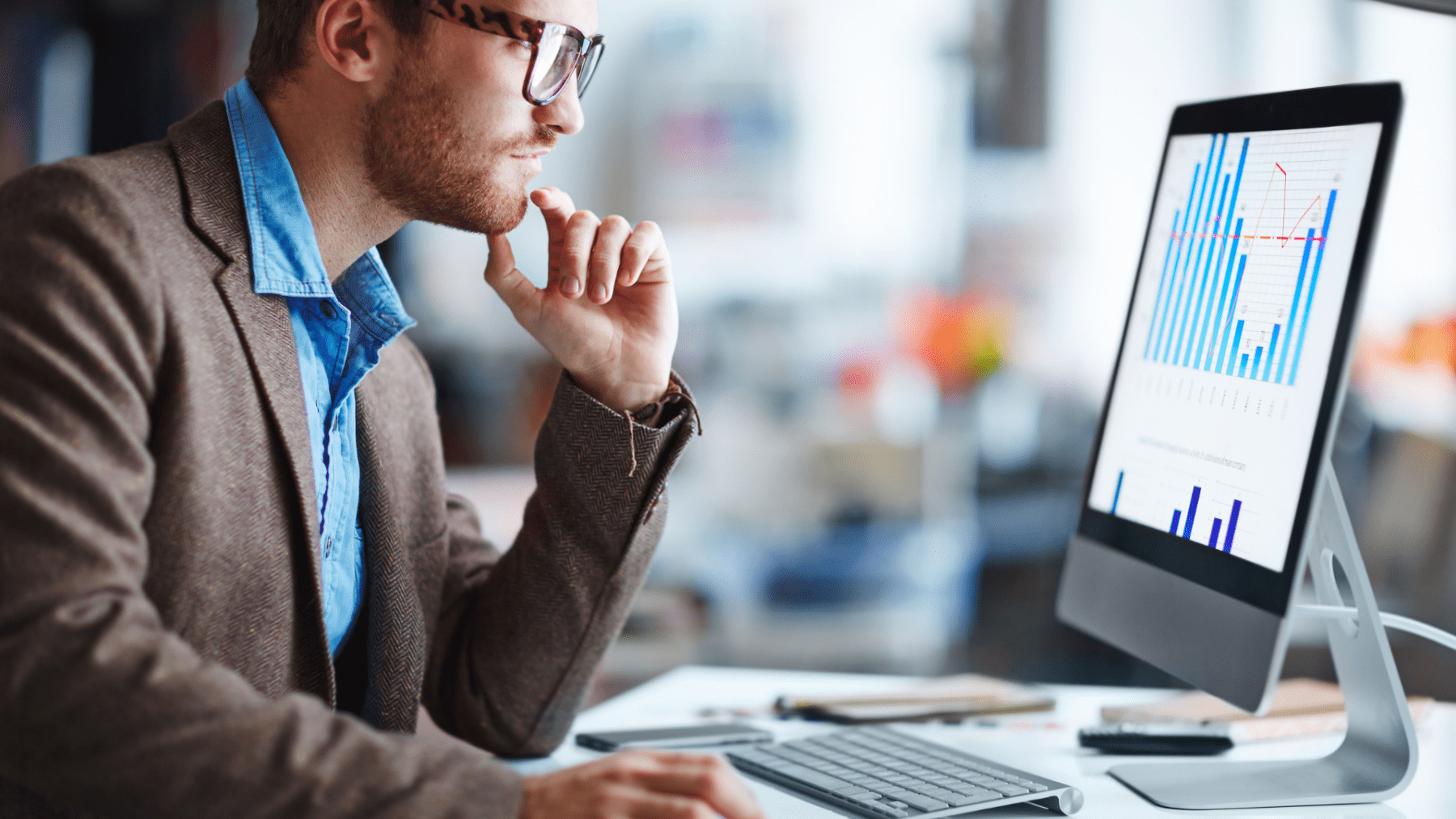 Man staring at keyword research graphs